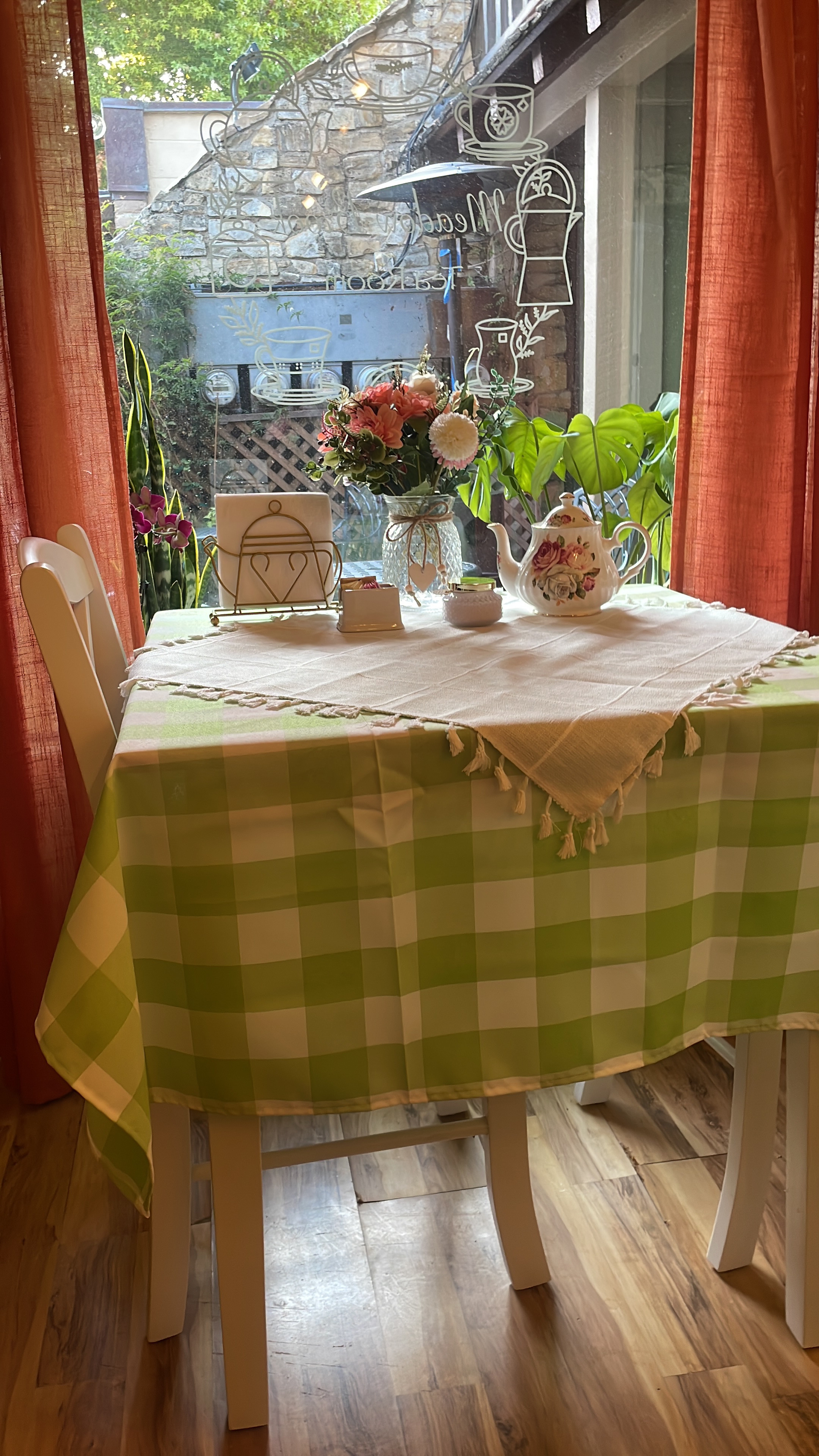 Tea table with teapot and place settings